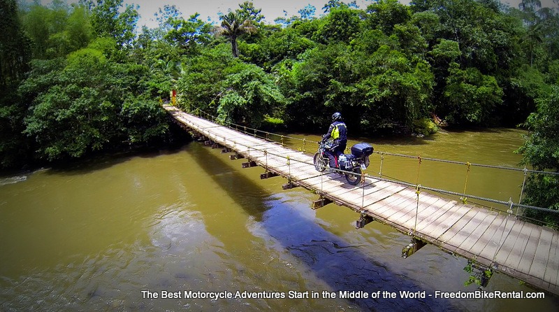 motorcycle riding over a suspension bridge in Ecuador