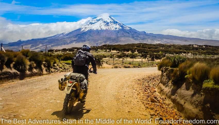 riding a motorcycle on a dirt road in Ecuador