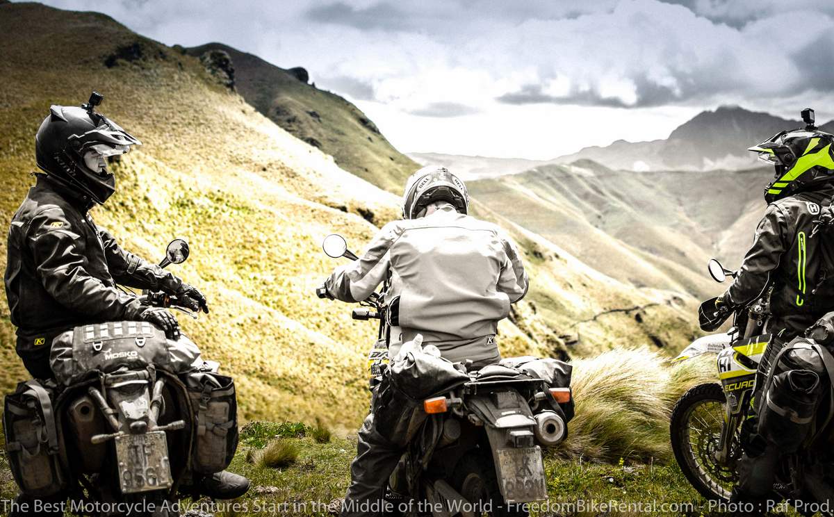 three dual sport motorcycles stopped for a break looking at the Andes Mountains in Ecuador
