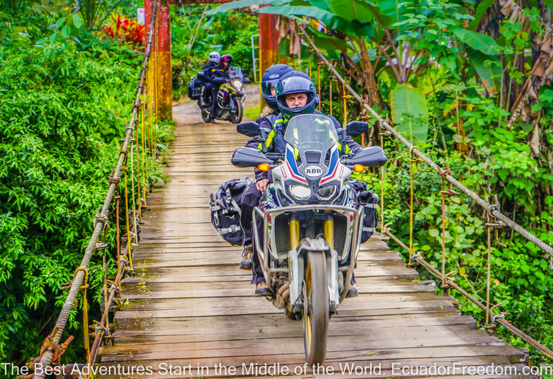 Honda Africa Twin two up crossing a suspension bridge in Ecuador