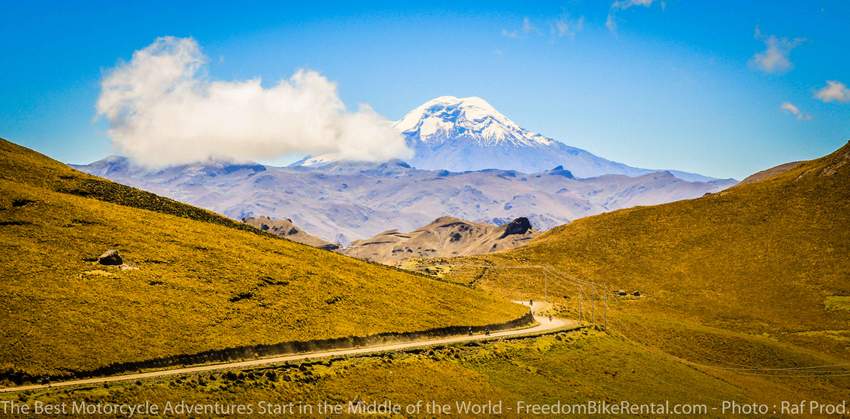 Riding motorcycle with Chimborazo in the background on dirt road