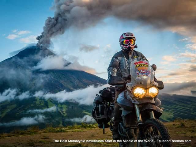 Triumph adventure motorcycle with erupting Tungurahua volcano in background