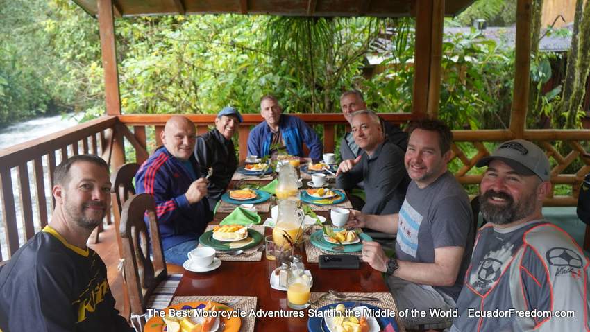 a group dual sport motorcycle tour enjoying breakfast in ecuador
