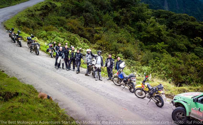 a guided dual sport motorcycle tour in Ecuador stopped for a break waving to the camera