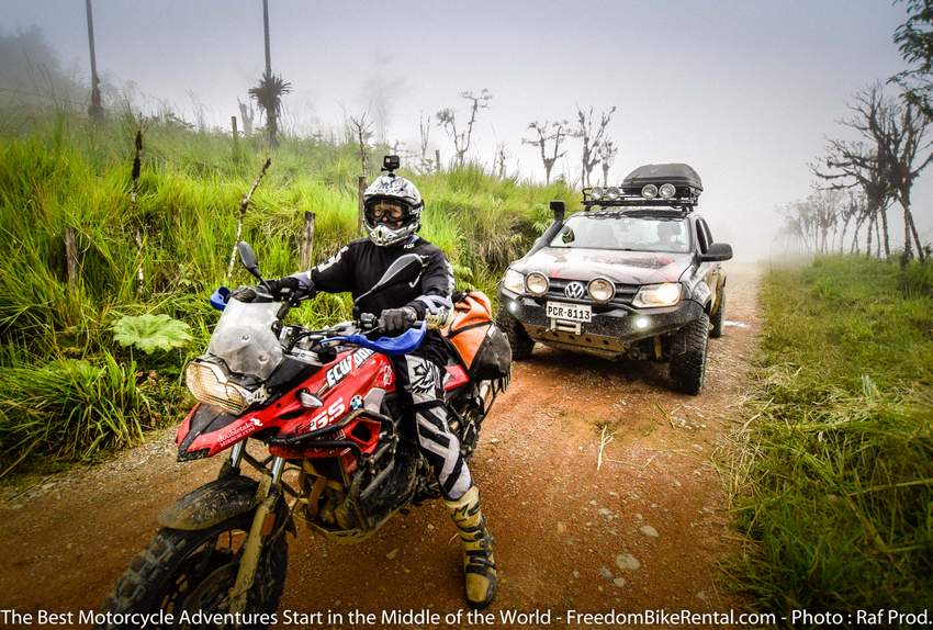 adventure rider on a bmw f700gs in Ecuador with a VW Amarok support truck behind him