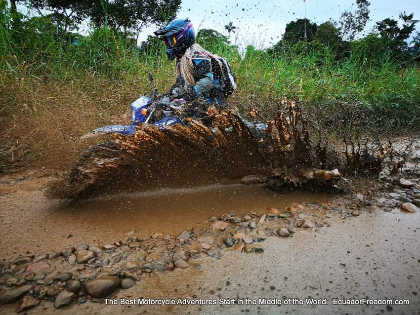 egle woman motorcycle rider going through mud puddle on yamaha xt250