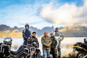 guided motorcycle tour group at high elevation mojanda lake in ecuador