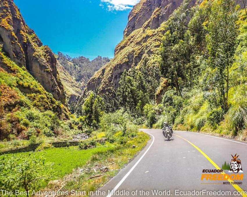 happy motorcyclists riding a self guided motorcycle tour in Ecuador in a canyon road with curves