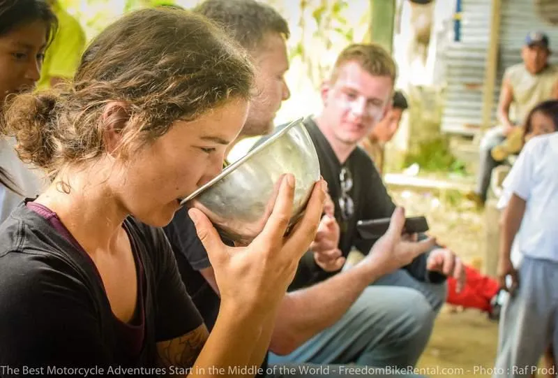 drinking chicha in the ecuador amazon during motorcycle adventure tour