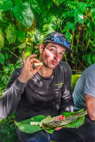 enjoying fish meal in the ecuador amazon jungle on motorcycle adventure tour