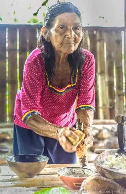 woman preparing food in ecuador amazon basin on motorcycle tour