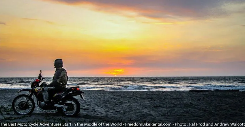 Motorcycle Suzuki DR650 on Canoa Beach at sunset
