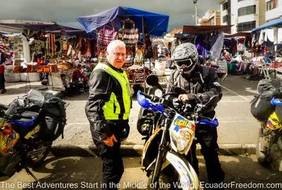 the market at saquisili with adventure motorcyclists taking a stop