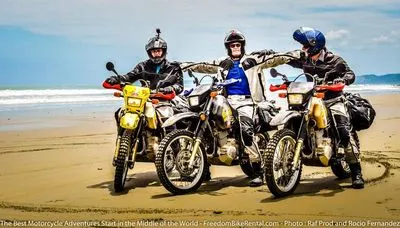 three motorcyclists on a beach in manabi ecuador having a good time