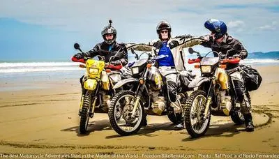 3 amigos on suzuki dr650 on beach in ecuador motorcycle adventure tour