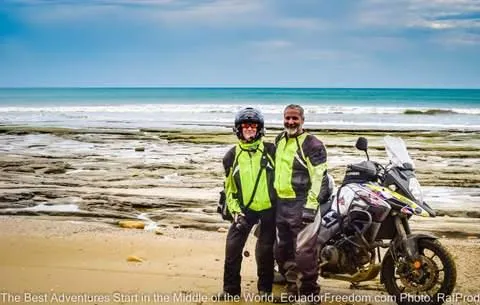 couple on beach in ecuador motorcycle tour happy beach