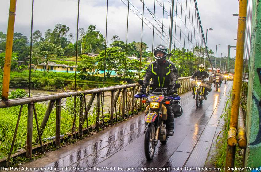 motorcycle adventure riders crossing a metal bridge in the Amazon basin