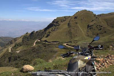 motorcycle overlooking dirt switchback road in Ecuador