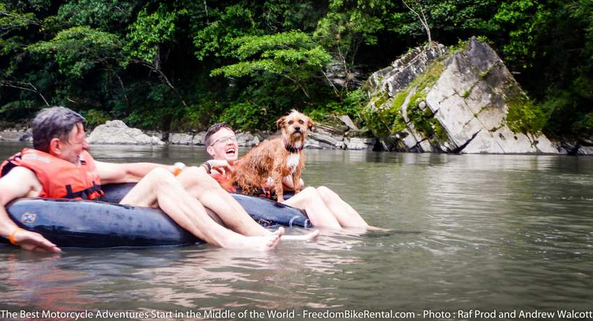 tubing down a river in the ecuadorian amazon basin on a motorcycle adventure ride