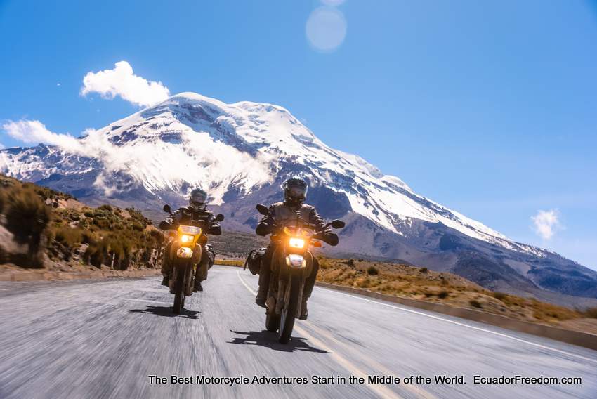two suzuki dr650 riding with chimborazo snow capped volcano in the background